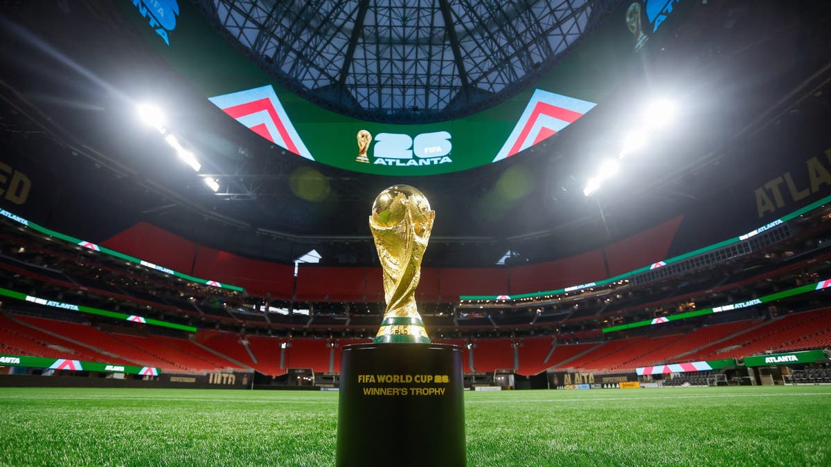 The FIFA World Cup trophy is displayed on the field of the Mercedes-Benz Stadium in Atlanta, Georgia. (Photo by Stew Milne/FIFA via Getty Images)