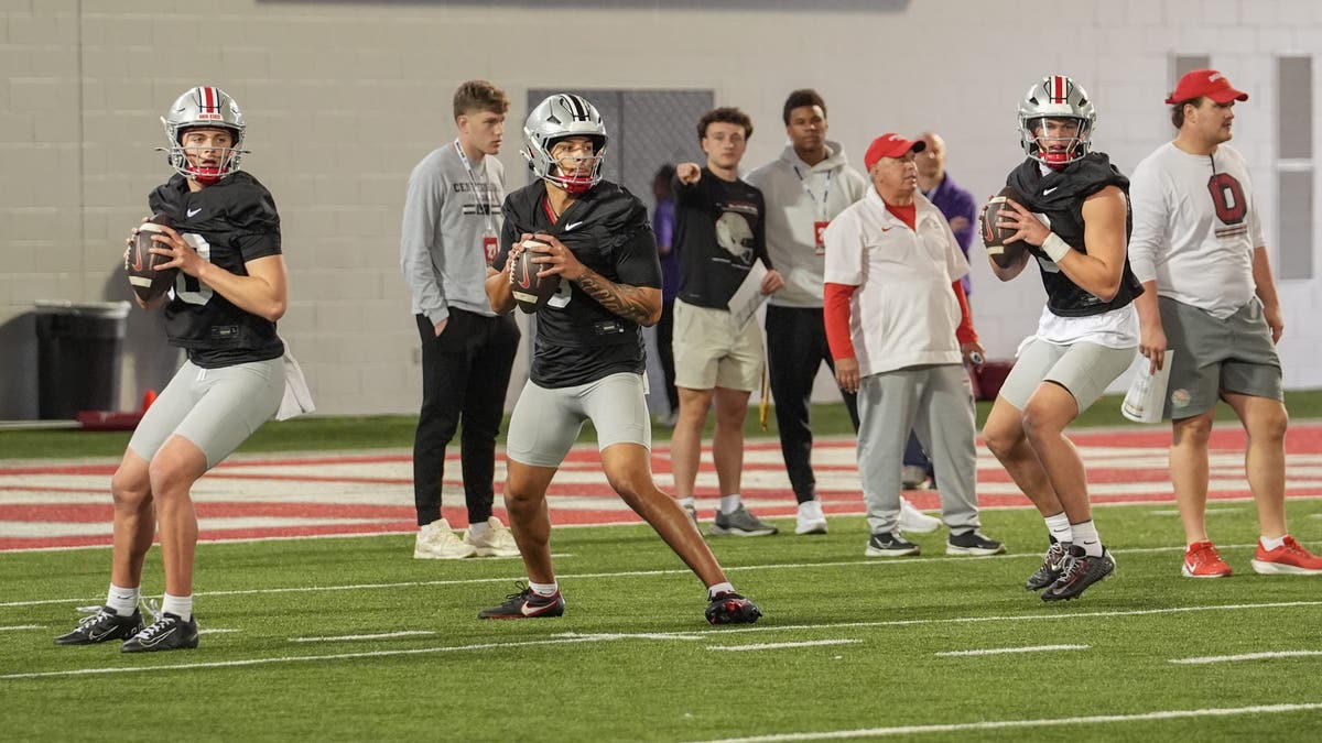 Julian Sayin #10, Tavien St. Clair #9 and Lincoln Kienholz #3 of Ohio State drop back to pass the ball during spring practice. (Photo by Jason Mowry/Getty Images)