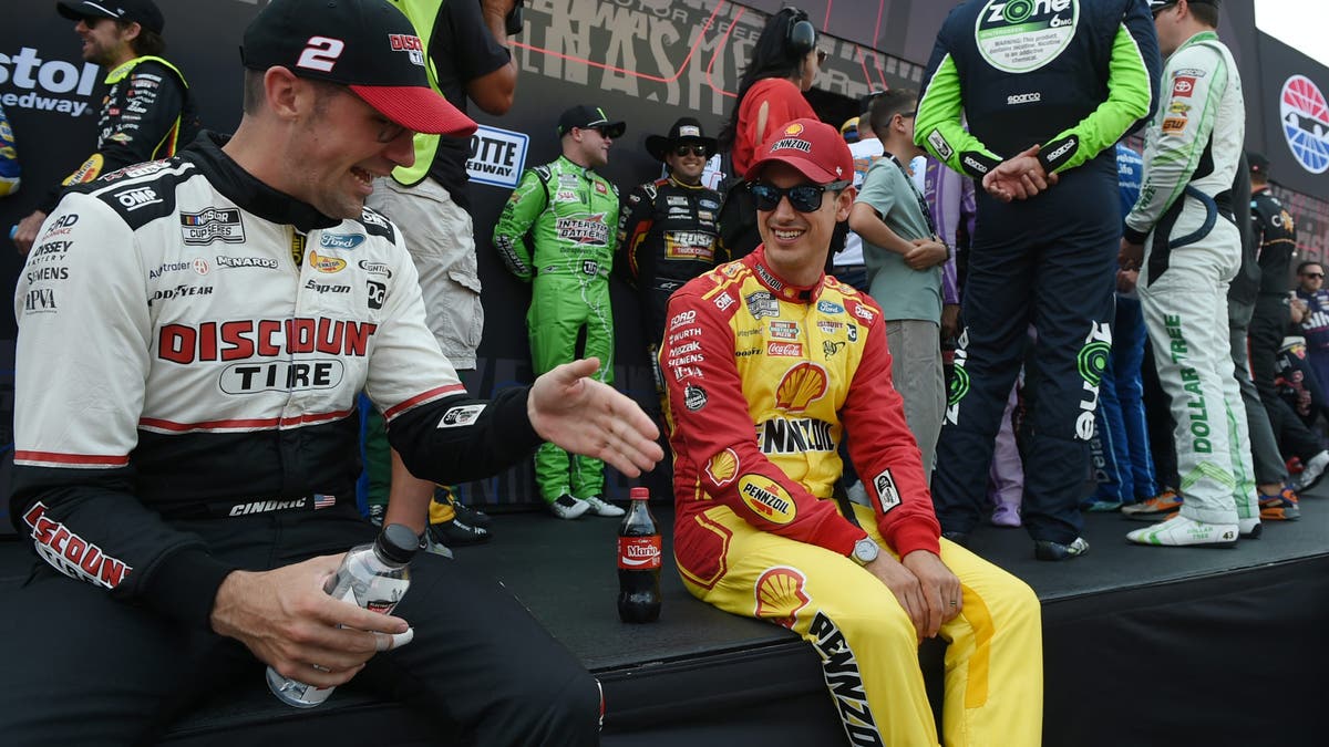 Team Penske teammates Austin Cindric and Joey Logano chat prior to the Cracker Barrel 400.