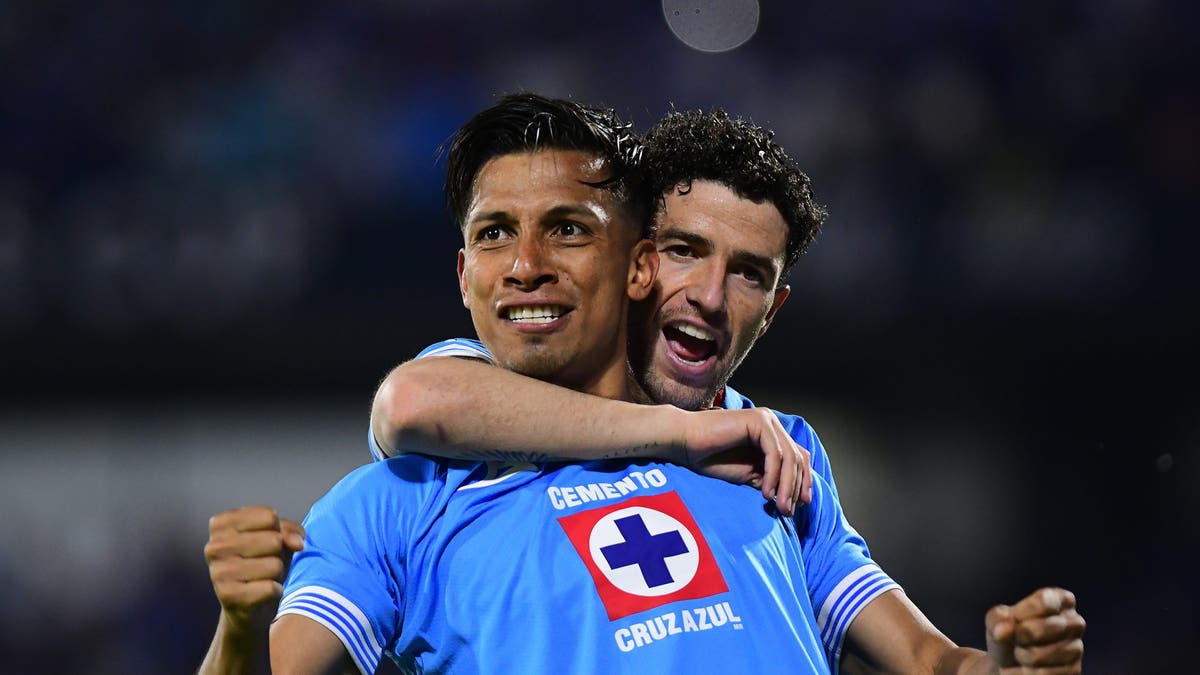 Angel Sepulveda (L) of Cruz Azul celebrates with Jose Ignacio Rivero (R) after scoring the team's fifth goal at Estadio Olimpico Universitario. (Photo by Jaime Lopez/Jam Media/Getty Images)