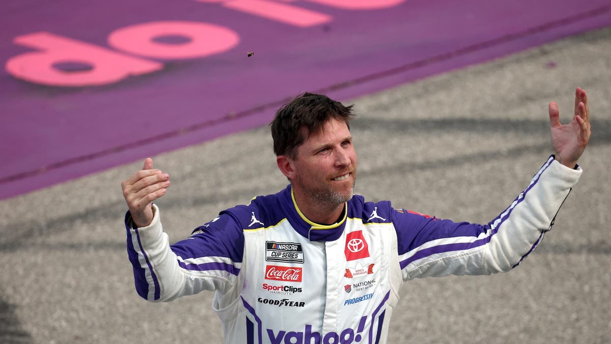 Denny Hamlin celebrates after winning the NASCAR Cup Series FireKeepers Casino 400 at Michigan International Speedway