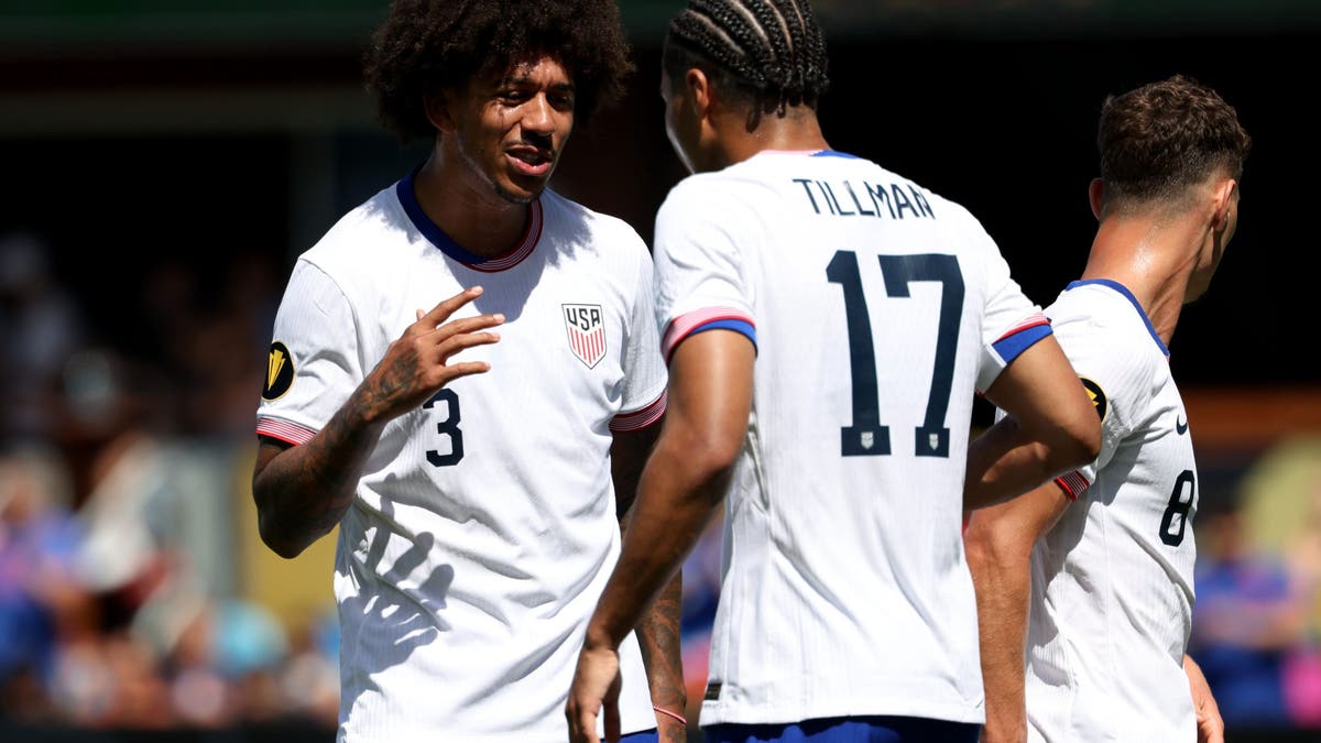 Chris Richards helps Malik Tillman celebrate one of his two goals on Sunday at PayPal Park. (Photo by Jed Jacobsohn/Getty Images)
