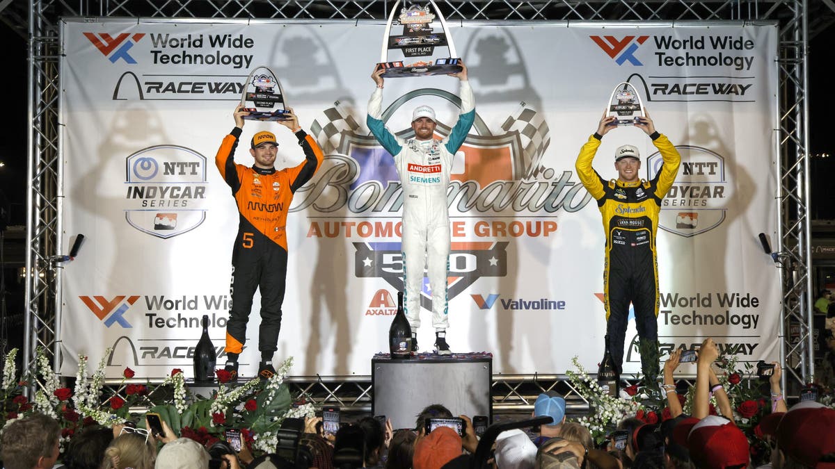 Pato O'Ward (left) of Arrow McLaren celebrates on the podium after the INDYCAR race at St. Louis