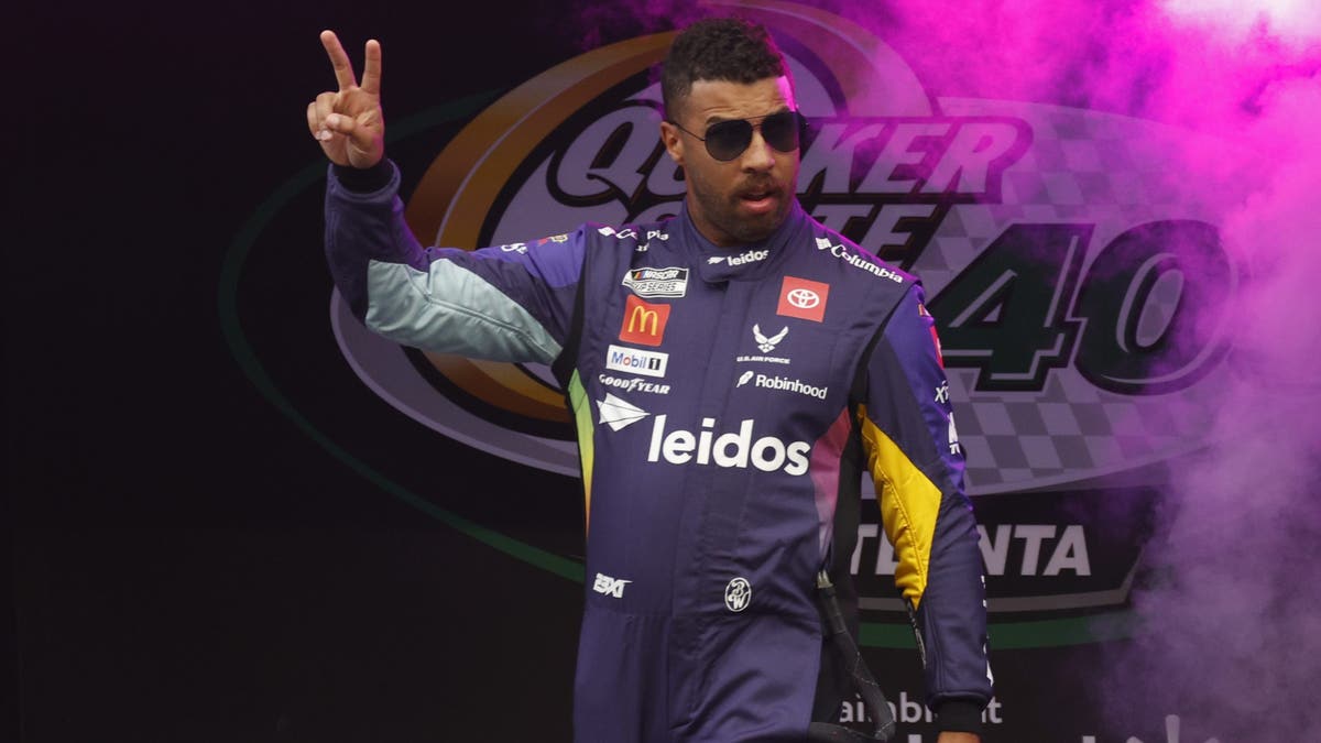 Bubba Wallace waves to the fans prior to the running of the NASCAR Cup Series Quaker State 400
