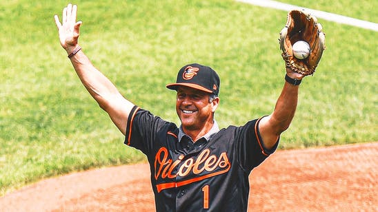 Jim Harbaugh gives advice after foul ball misses his brother and Cal Ripken Jr.