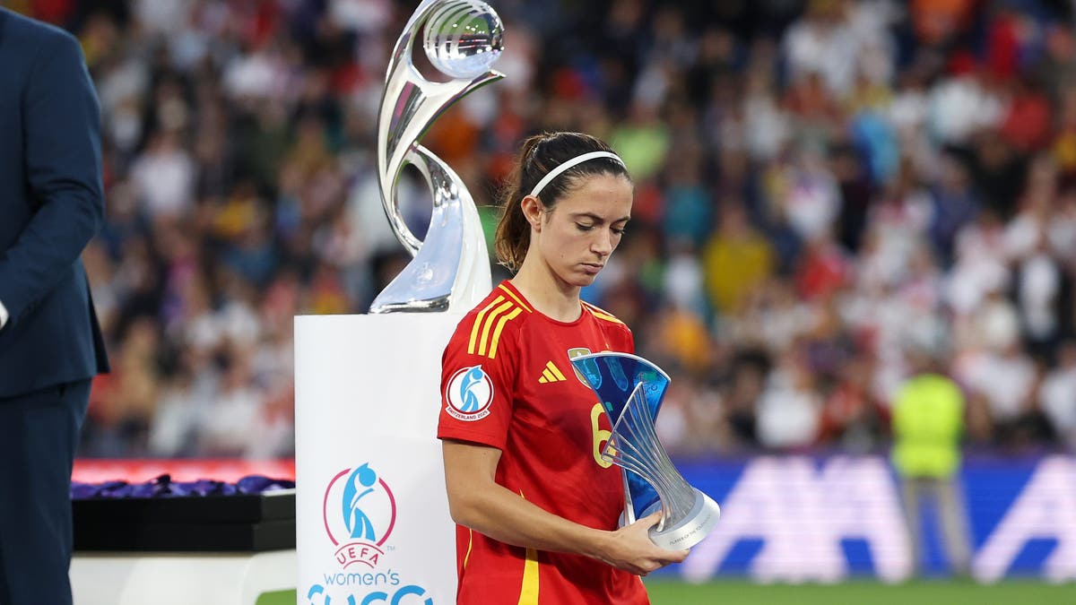Aitana Bonmatí walks past the Euro trophy after Spain lost the final, although she did win the Player of the Tournament award (Photo by Charlotte Wilson/Getty Images)