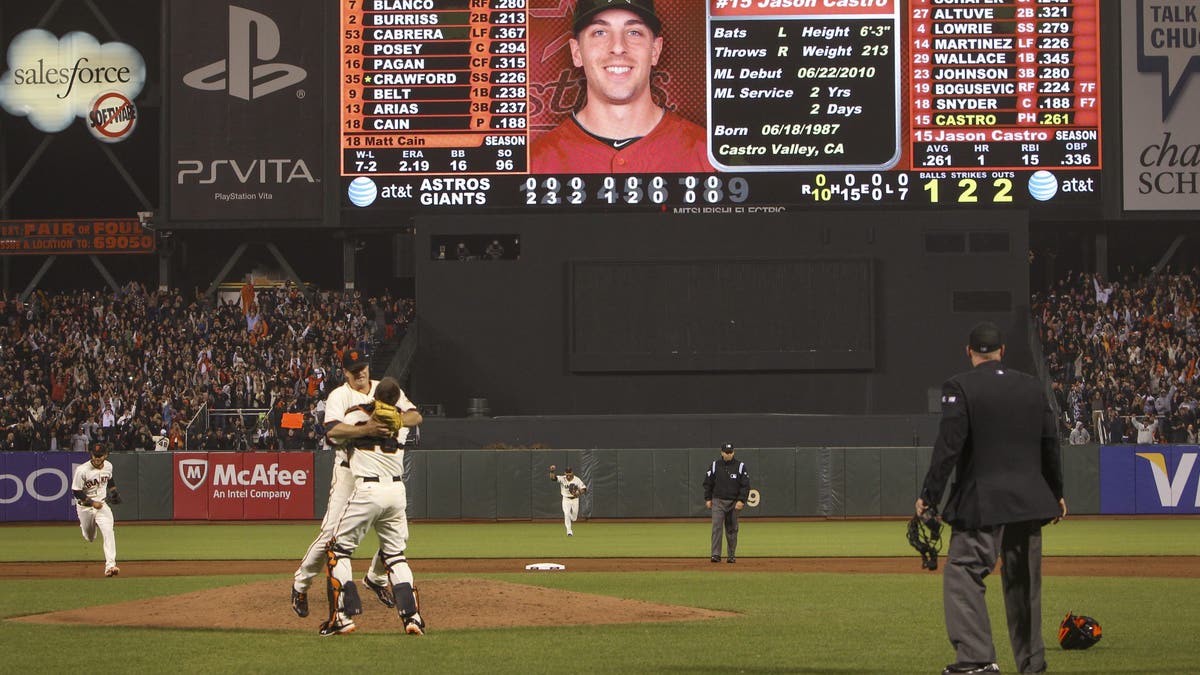 Matt Cain and Buster Posey shared an embrace following the Giants pitcher's perfect game in 2012. (Photo by Missy Mikulecky/MLB via Getty Images)