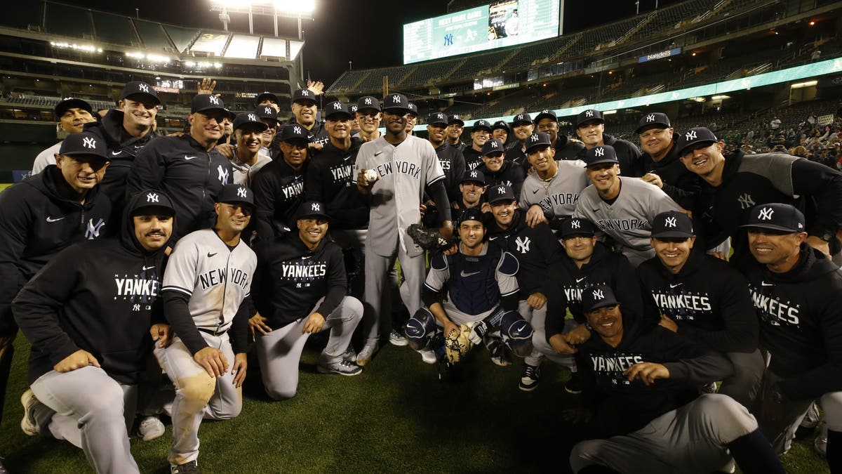 Domingo German and his Yankees teammates posed for a picture following his perfect game in 2023. (Photo by Michael Zagaris/Oakland Athletics/Getty Images)