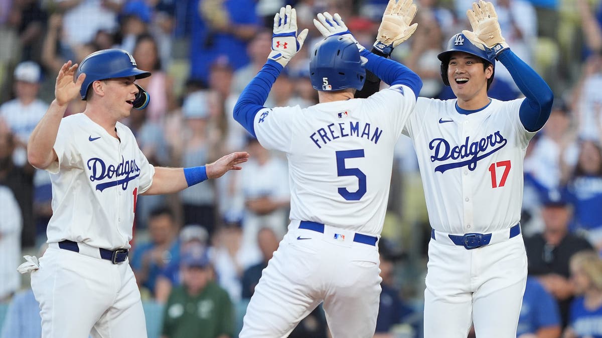 Freddie Freeman #5 of the Los Angeles Dodgers celebrates with teammates Shohei Ohtani #17 and Will Smith #16 after hitting a three-run home run against the Arizona Diamondbacks on July 03, 2024 in Los Angeles. (Photo by Michael Owens/Getty Images)