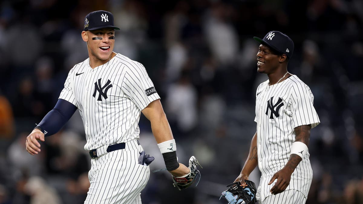 Aaron Judge #99 and Jazz Chisholm Jr. #13 of the New York Yankees celebrate their win over the Kansas City Royals at Yankee Stadium on April 15, 2025 in the Bronx. (Photo by Elsa/Getty Images)