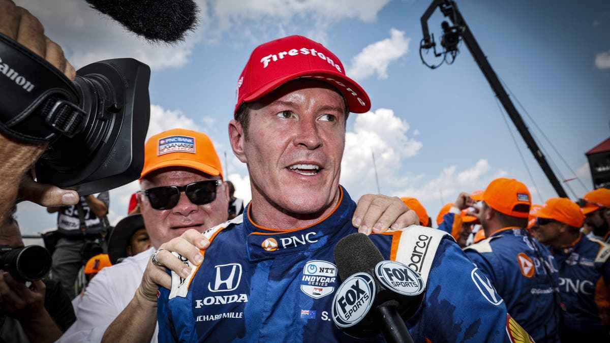 Scott Dixon celebrates in victory lane with team owner Chip Ganassi during the NTT IndyCar Series Honda Indy 200 at Mid-Ohio