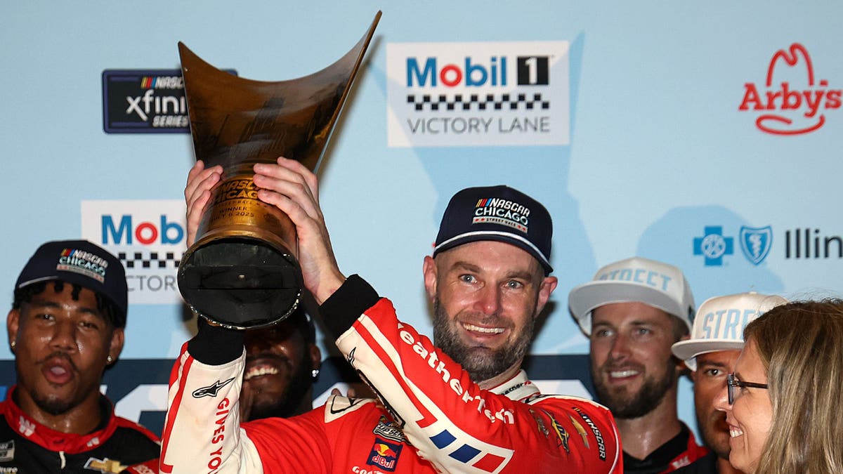 Shane van Gisbergen celebrates in victory lane after winning the NASCAR Cup Series Grant Park 165 at Chicago Street Course