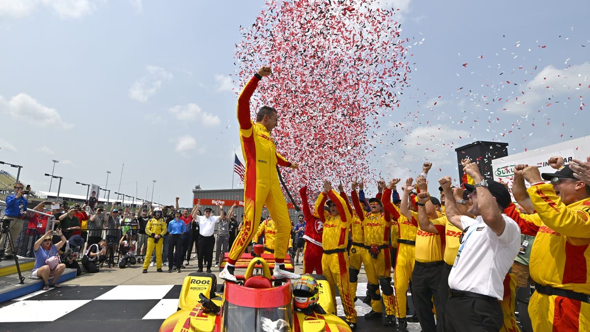 Alex Palou celebrates in victory lane with his team during Race 2 at Iowa Speedway