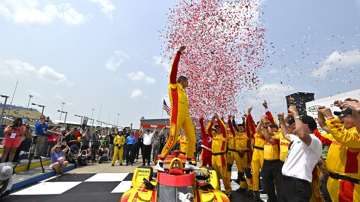 Alex Palou celebrates in victory lane with his team during the INDYCAR Series Sukup Race Weekend Race 2 at Iowa Speedway on July 13, 2025 