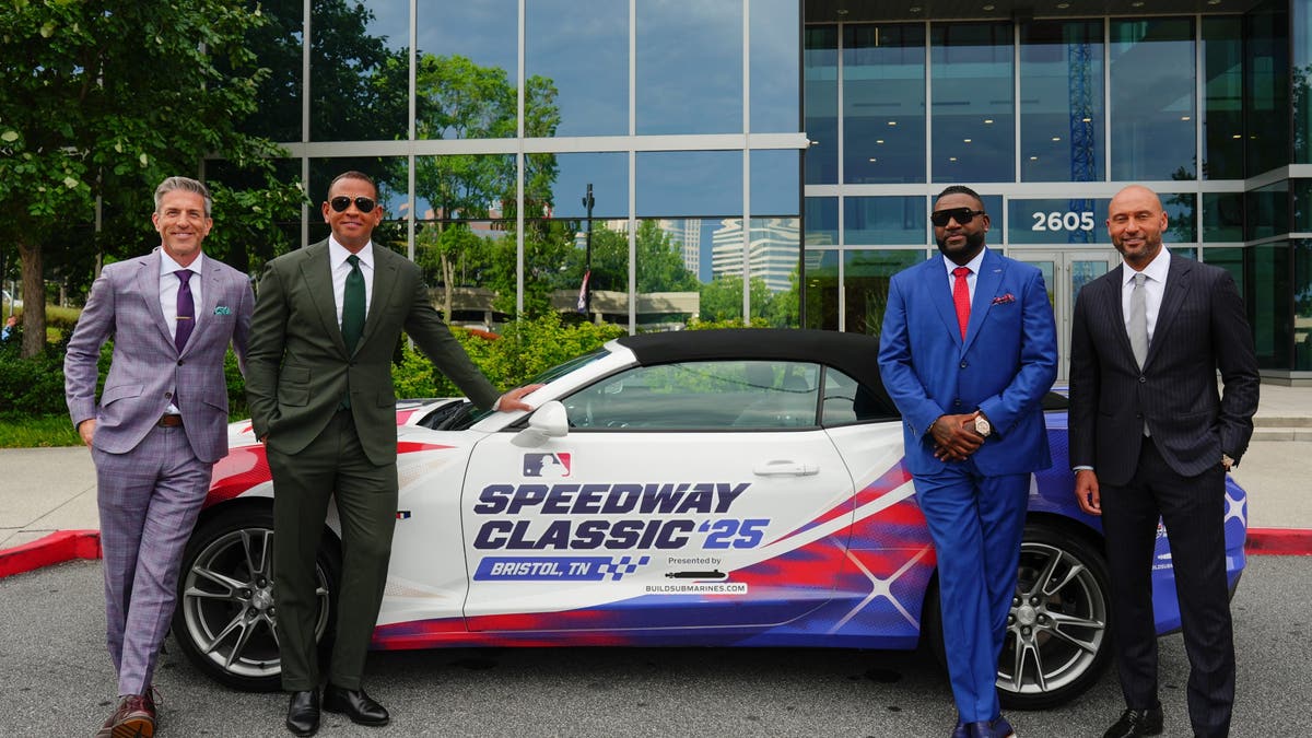Kevin Burkhardt, Alex Rodriguez, David Ortiz and Derek Jeter pose with a car sporting the Major League Baseball Speedway Classic 2025 wrap