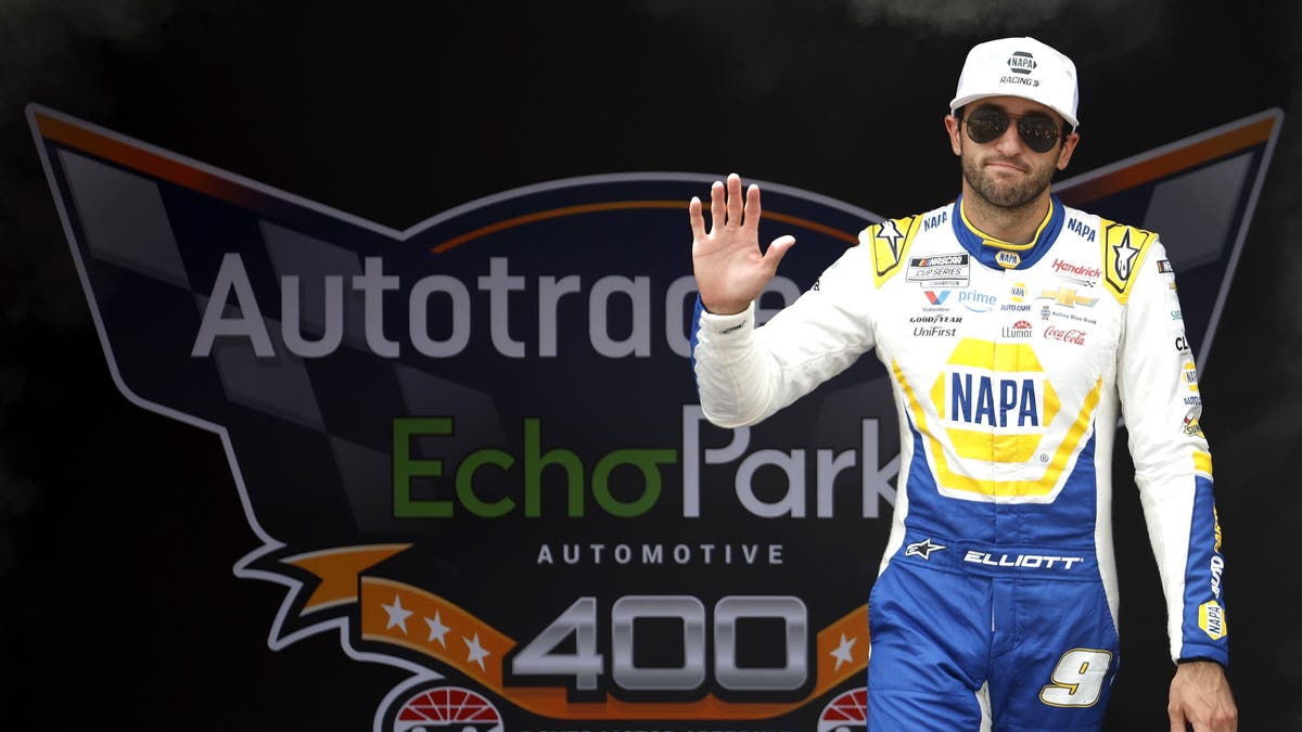 Chase Elliott waves to fans as he walks onstage during driver intros prior to green flag at Dover
