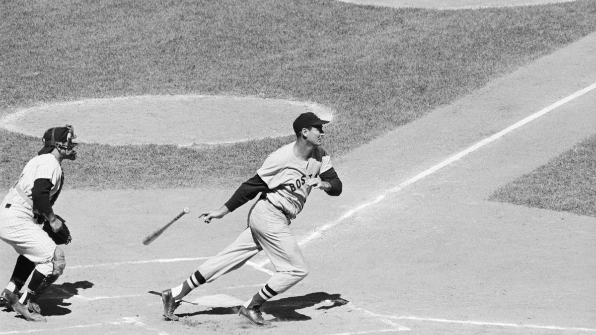 Ted Williams heads for first base after hitting a ground ball in the 1st inning of the Yanks-Red Sox game. (via Getty)