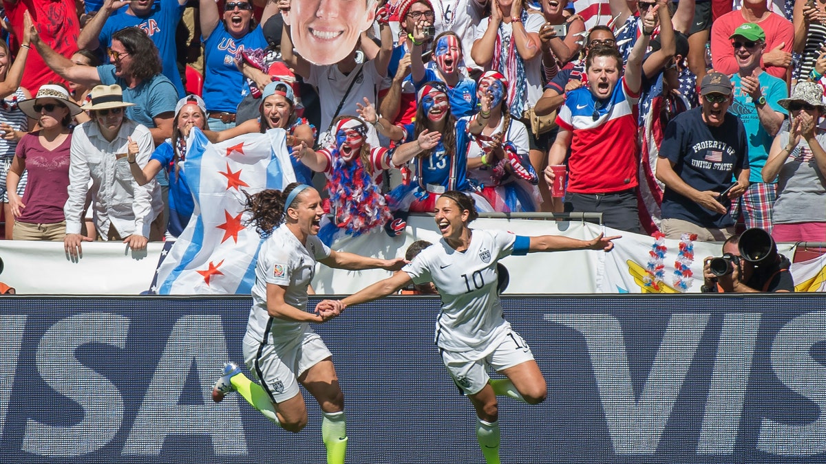 Lauren Holiday of Team USA and Carli Lloyd of Team USA celebrate Lloyd's second goal during 2015 Women's World Cup in Vancouver, during the final between USA and Japan. (Photo by Christopher Morris/Corbis via Getty Images)