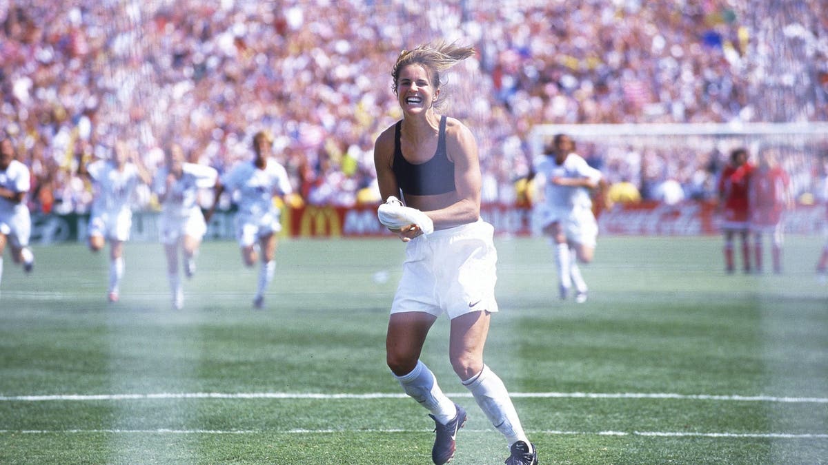 Brandi Chastain celebrates after scoring the game-winning penalty kick vs China. (Photo by Robert Beck /Sports Illustrated via Getty Images)