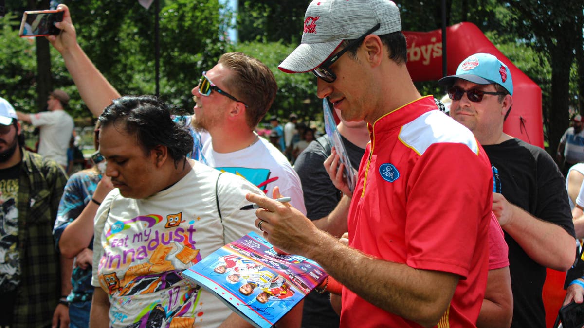 Joey Logano talks with fans and signs autographs in the Festival Field before heading to his garage. (Photo by Ed McGregor/FOX Sports)