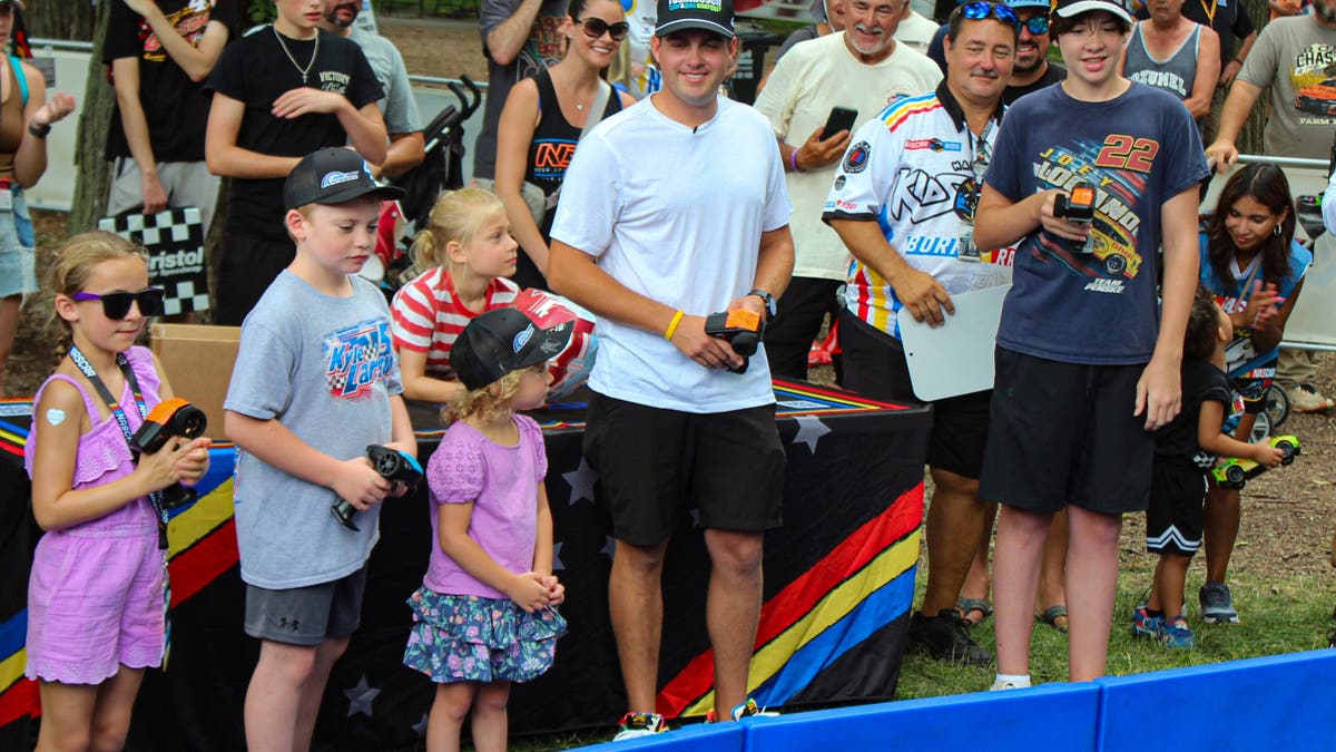 A couple of hours before strapping himself into a rocket, Noah Gragson races remote-controlled cars against young fans in the NASCAR Kids Zone. (Photo by Ed McGregor/FOX Sports)