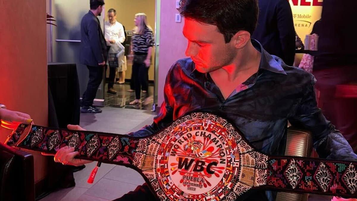 Pato O'Ward holds fellow Mexican star Canelo Alvarez's WBC title belt. (via O'Ward's Instagram)