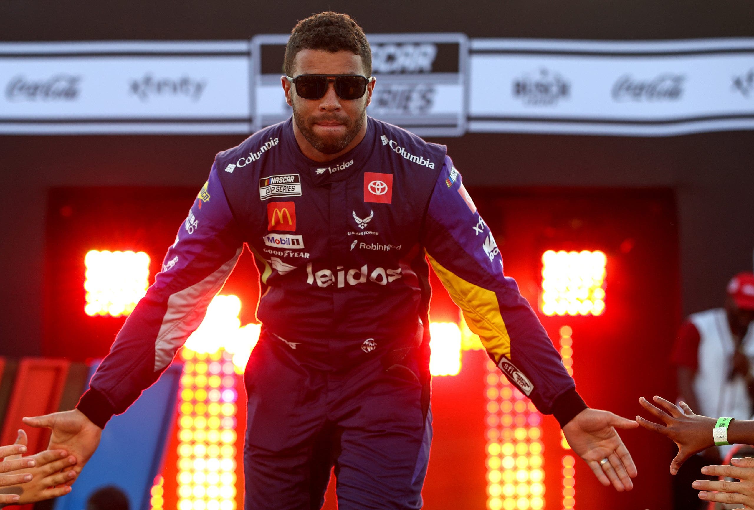 Bubba Wallace greets fans as he walks on stage during driver intros prior to Richmond