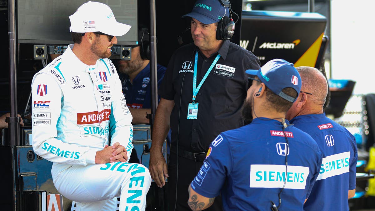 Back at the timing stand, Kirkwood talks with Bryan Herta (black shirt), who runs his strategy, prior to qualifying. Herta is a former driver and car owner — and the father of Kyle's teammate, Colton Herta. (Photo by Ed McGregor/FOX Sports)