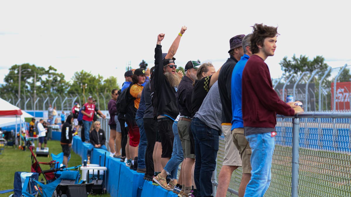 Wisconsin fans are known for their passion for racing. Here they line up along a wall on the backstretch to get a closer look. (Photo by Ed McGregor/FOX Sports)