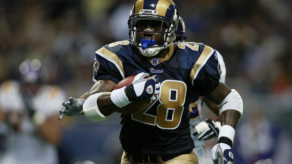 Marshall Faulk led the NFL in rushing touchdowns (18) in 2000 as he won the MVP. (Photo by Dilip Vishwanat/Sporting News via Getty Images via Getty Images)
