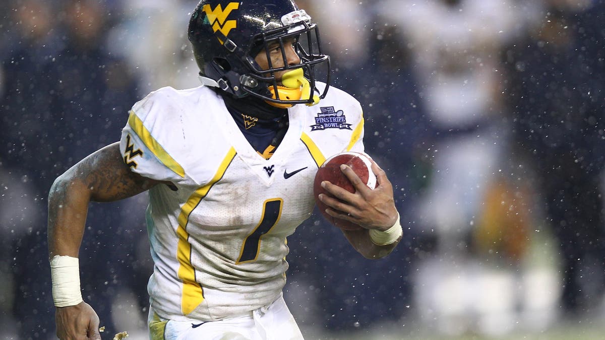 While he primarily played wide receiver at West Virginia, Tavon Austin had a few outings at running back. (Photo by Nate Shron/Getty Images)