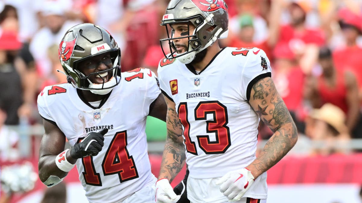 Chris Godwin #14 of the Tampa Bay Buccaneers celebrates with Mike Evans #13 after he scored a touchdown in the second quarter of the game against the Washington Commanders at Raymond James Stadium on September 08, 2024 in Tampa, Florida. (Photo by Julio Aguilar/Getty Images)