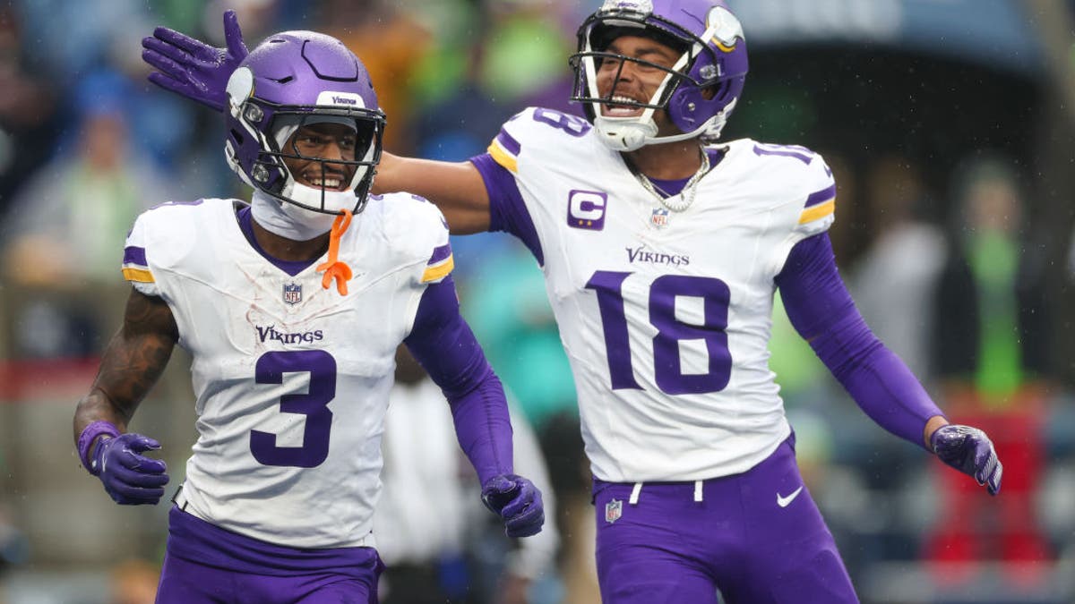 Justin Jefferson #18 of the Minnesota Vikings celebrates with Jordan Addison #3 after Addison scored a touchdown in the first quarter of a game against the Seattle Seahawks at Lumen Field on December 22, 2024 in Seattle, Washington. (Photo by Steph Chambers/Getty Images)