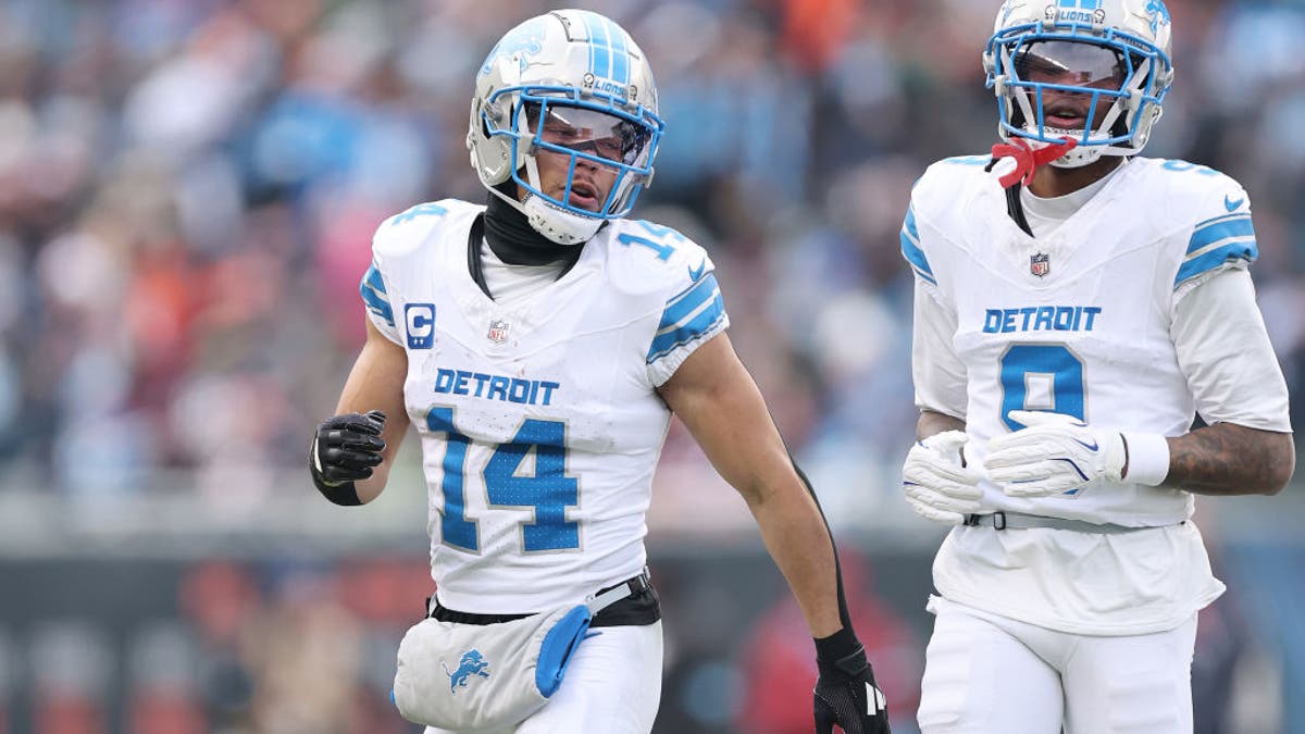 Amon-Ra St. Brown #14 and Jameson Williams #9 of the Detroit Lions look on against the Chicago Bears at Soldier Field on December 22, 2024 in Chicago, Illinois. (Photo by Michael Reaves/Getty Images)