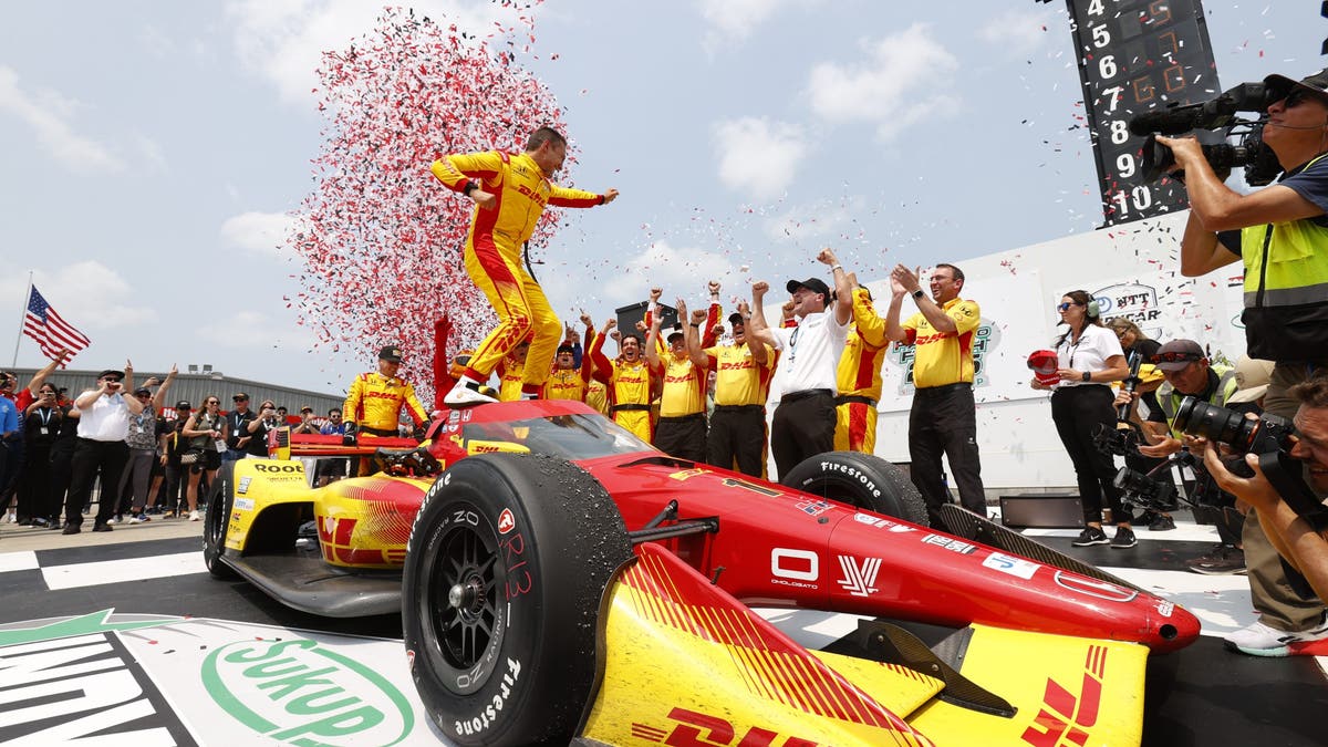 Alex Palou celebrates in victory lane after Race 2 at Iowa Speedway.