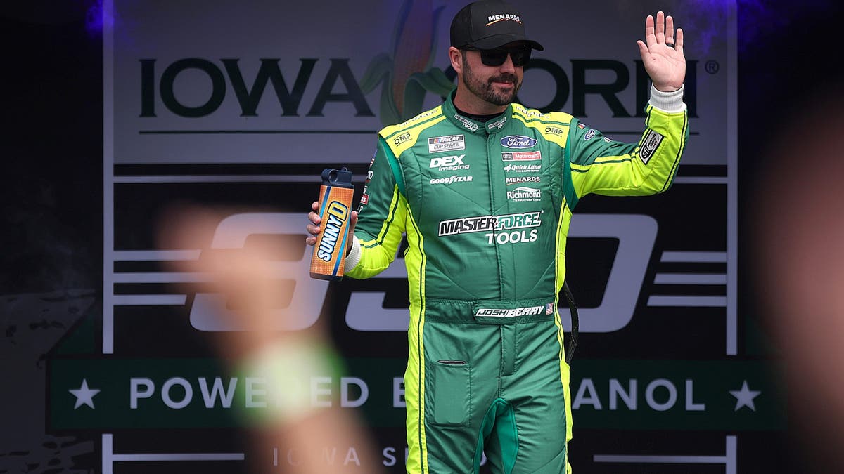 Josh Berry waves to fans as he walks onstage during driver intros prior to the NASCAR Cup Series Iowa Corn 350 