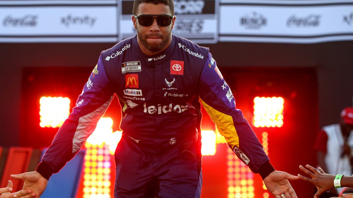 Bubba Wallace greets fans as he walks on stage during driver intros prior to Richmond