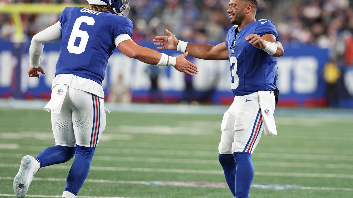 Jaxson Dart #6 of the New York Giants celebrates a touchdown against the New England Patriots with Russell Wilson #3 during their NFL Preseason game at MetLife Stadium on August 21, 2025 in East Rutherford, New Jersey. (Photo by Al Bello/Getty Images)