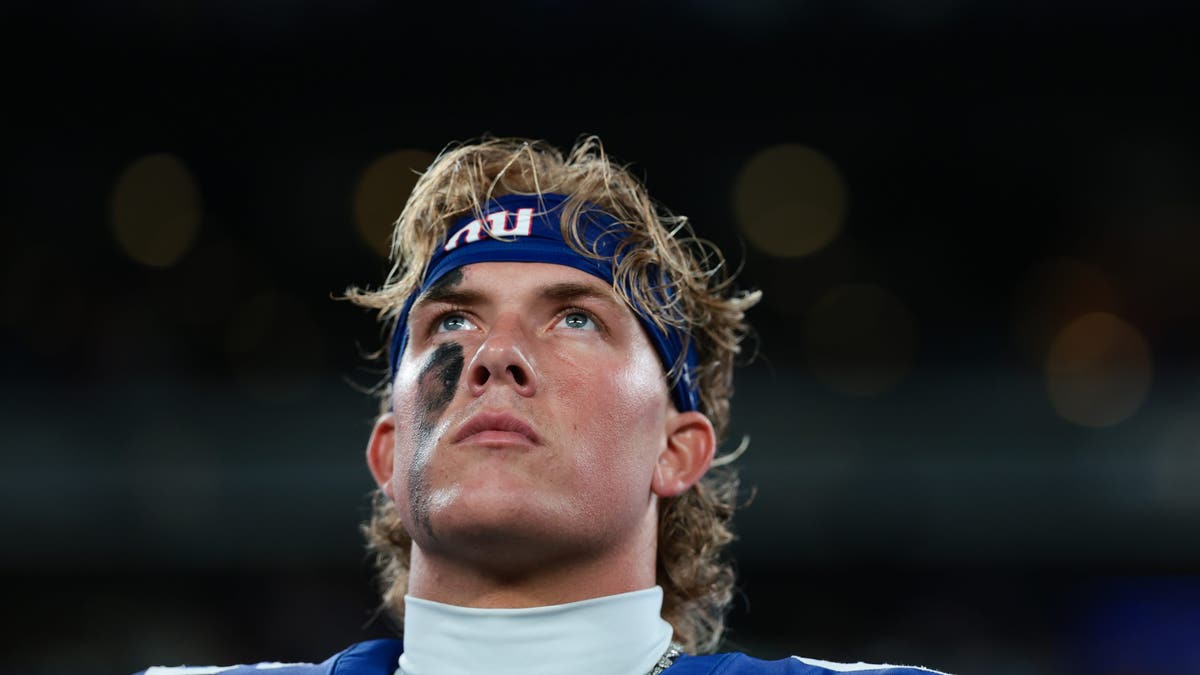 Jaxson Dart #6 of the New York Giants looks on during the national anthem prior to the NFL Preseason 2025 game against the New England Patriots at MetLife Stadium on August 21, 2025 in East Rutherford, New Jersey. (Photo by Kathryn Riley/Getty Images)