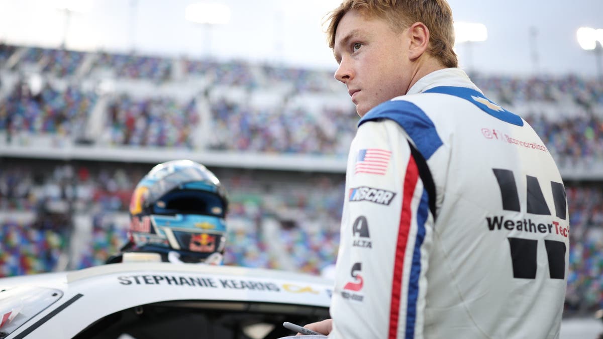 Connor Zilisch prepares to climb into his car prior to the race at Daytona.