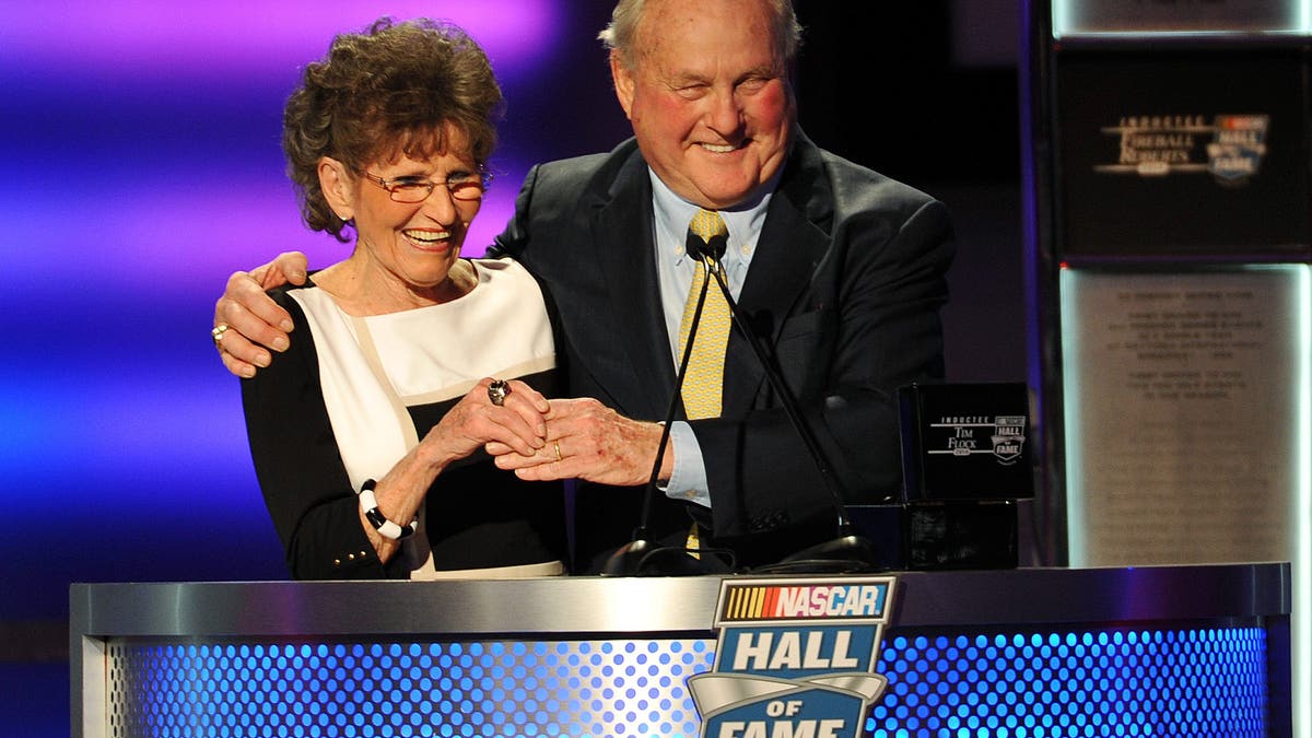 Frances Flock, wife of inductee Tim Flock, is presented the Hall of Fame ring by Humpy Wheeler during the NASCAR Hall of Fame induction ceremony in 2014. (Photo by Rainier Ehrhardt/NASCAR via Getty Images)