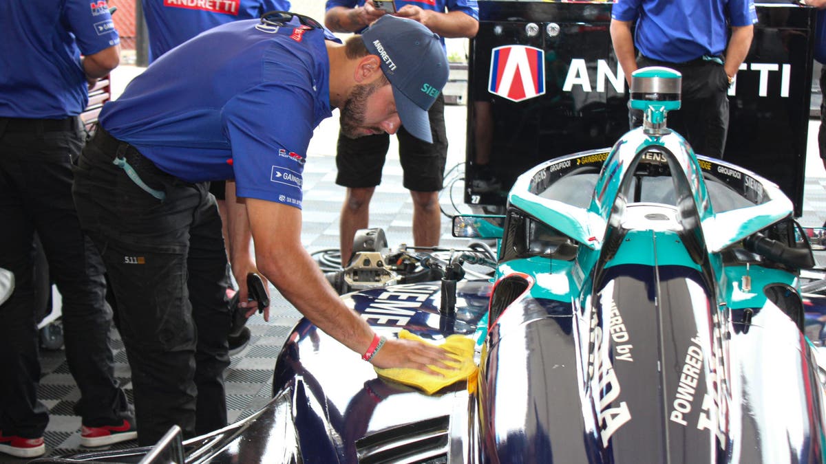 In the garage, a crew member wipes down the car. It's not just to make it look good. The crew wants the car to be as sleek as possible so it can be as fast as possible. (Photo by Ed McGregor/FOX Sports)
