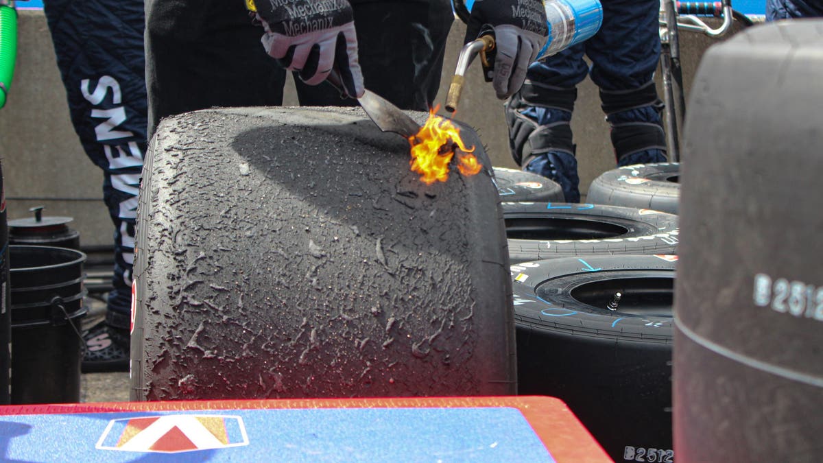 To check tire wear and air pressures, the team must first get the rubber that accumulates during the run off the tread. They do it by heating it and then scraping the area where they will measure the tire pressure. (Photo by Ed McGregor/FOX Sports)