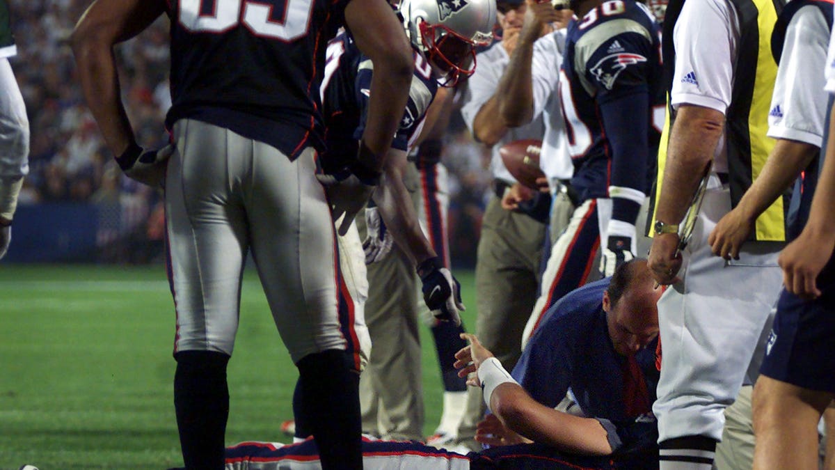 Drew Bledsoe remained down for several moments after taking a hard hit from Jets linebacker Mo Lewis, which wound up changing the course of NFL history. (Photo by Jim Davis/The Boston Globe via Getty Images)