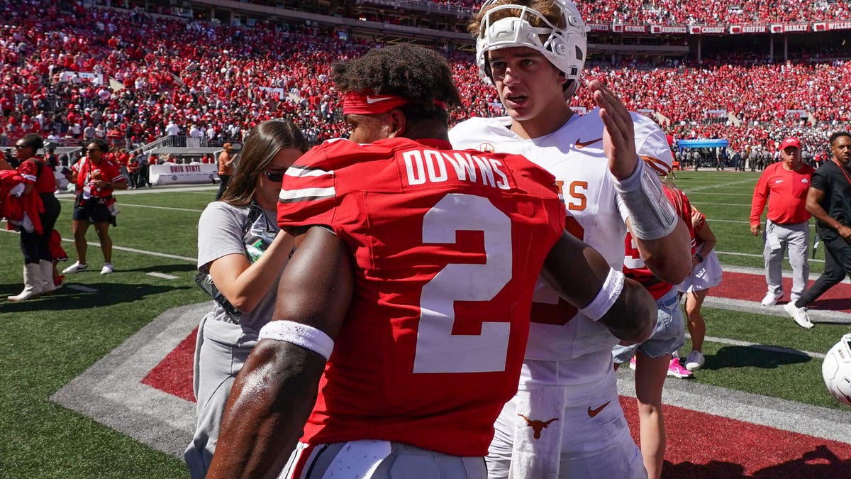 Quarterback Arch Manning #16 of Texas talks with Safety Caleb Downs #2 of Ohio State after the game at Ohio Stadium . (Photo by Jason Mowry/Getty Images)