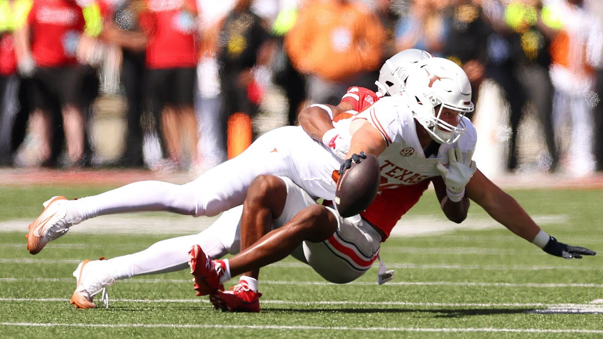 Jack Endries #88 of Texas tries to reach for a fourth quarter first down while being tackled by Caleb Downs #2 of the Ohio State Buckeyes (Photo by Gregory Shamus/Getty Images)