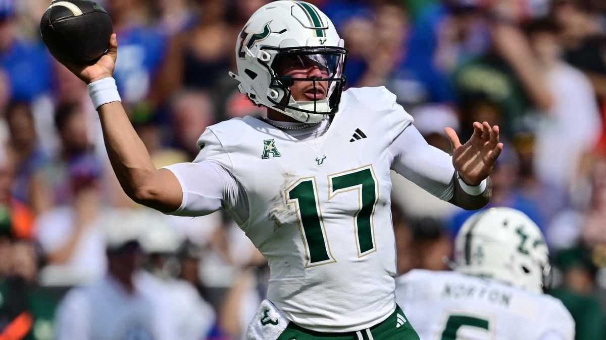 South Florida QB Byrum Brown #17 throws a pass against Florida at Ben Hill Griffin Stadium. (Photo by Julio Aguilar/Getty Images)