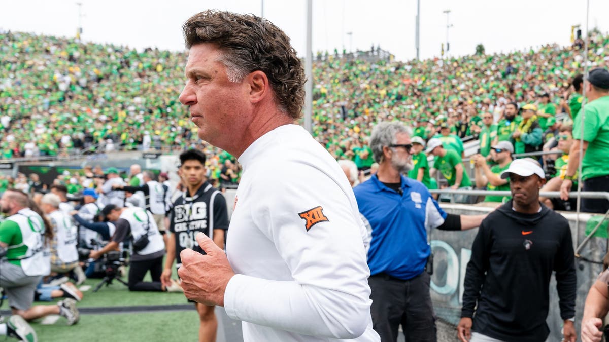 Head Coach Mike Gundy of the Oklahoma State Cowboys runs out onto the field before the game against the Oregon Ducks. (Photo by Ali Gradischer/Getty Images)