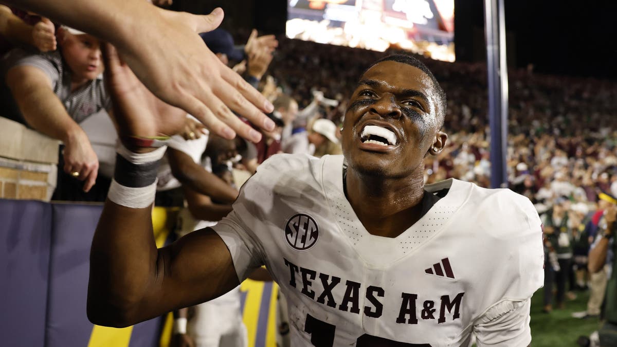 Marcel Reed #10 of the Texas A&amp;M Aggies high-fives fans after defeating the Notre Dame Fighting Irish. (Photo by Michael Reaves/Getty Images)