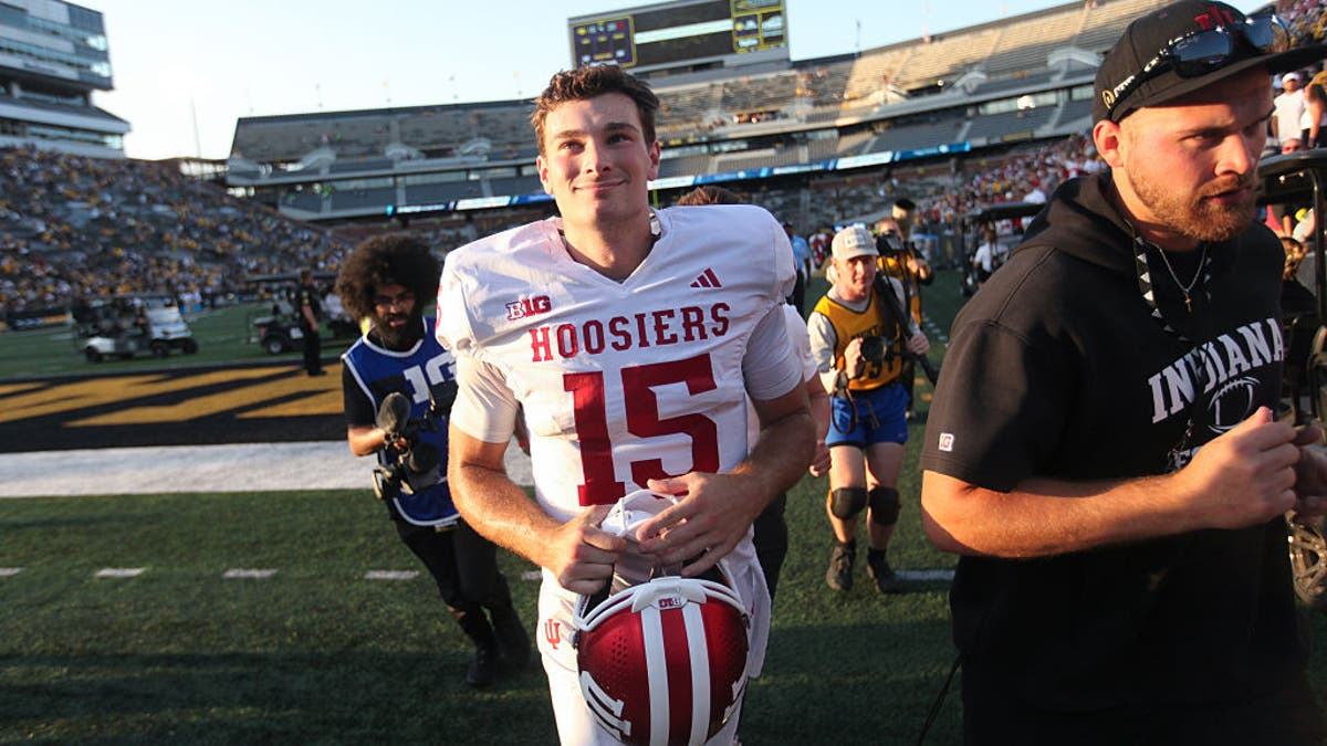 Quarterback Fernando Mendoza #15 of the Indiana Hoosiers smiles as he walks off the field after the matchup against the Iowa Hawkeyes. (Photo by Matthew Holst/Getty Images)